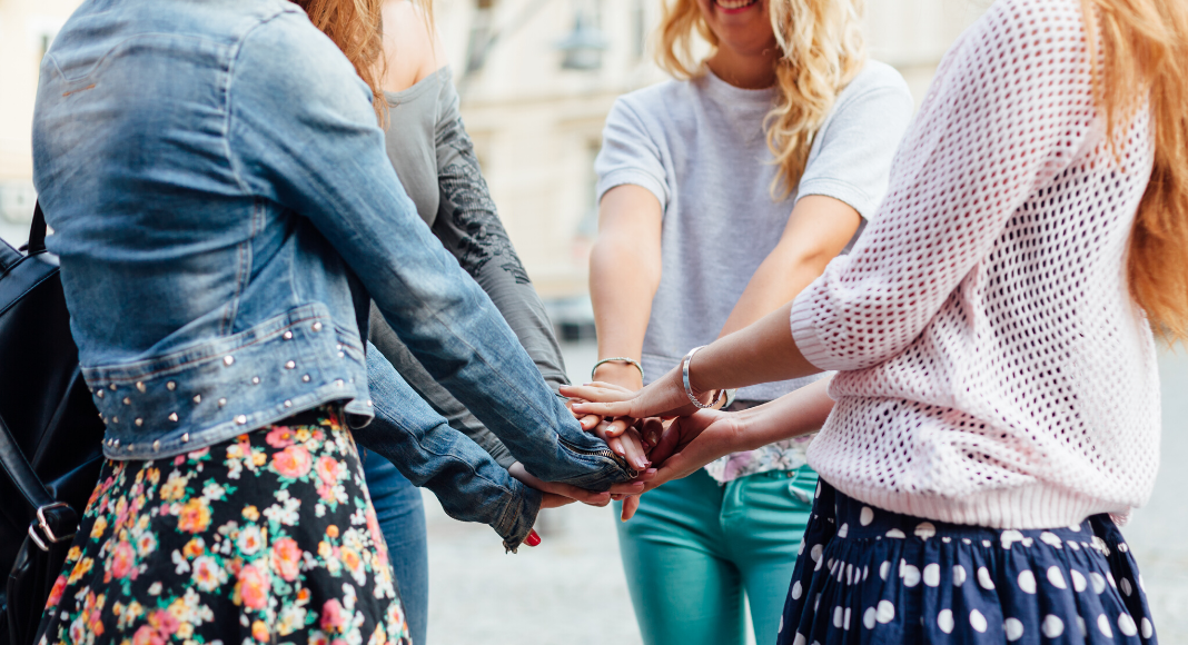 women putting hands in together, how i found my tribe of mom friends