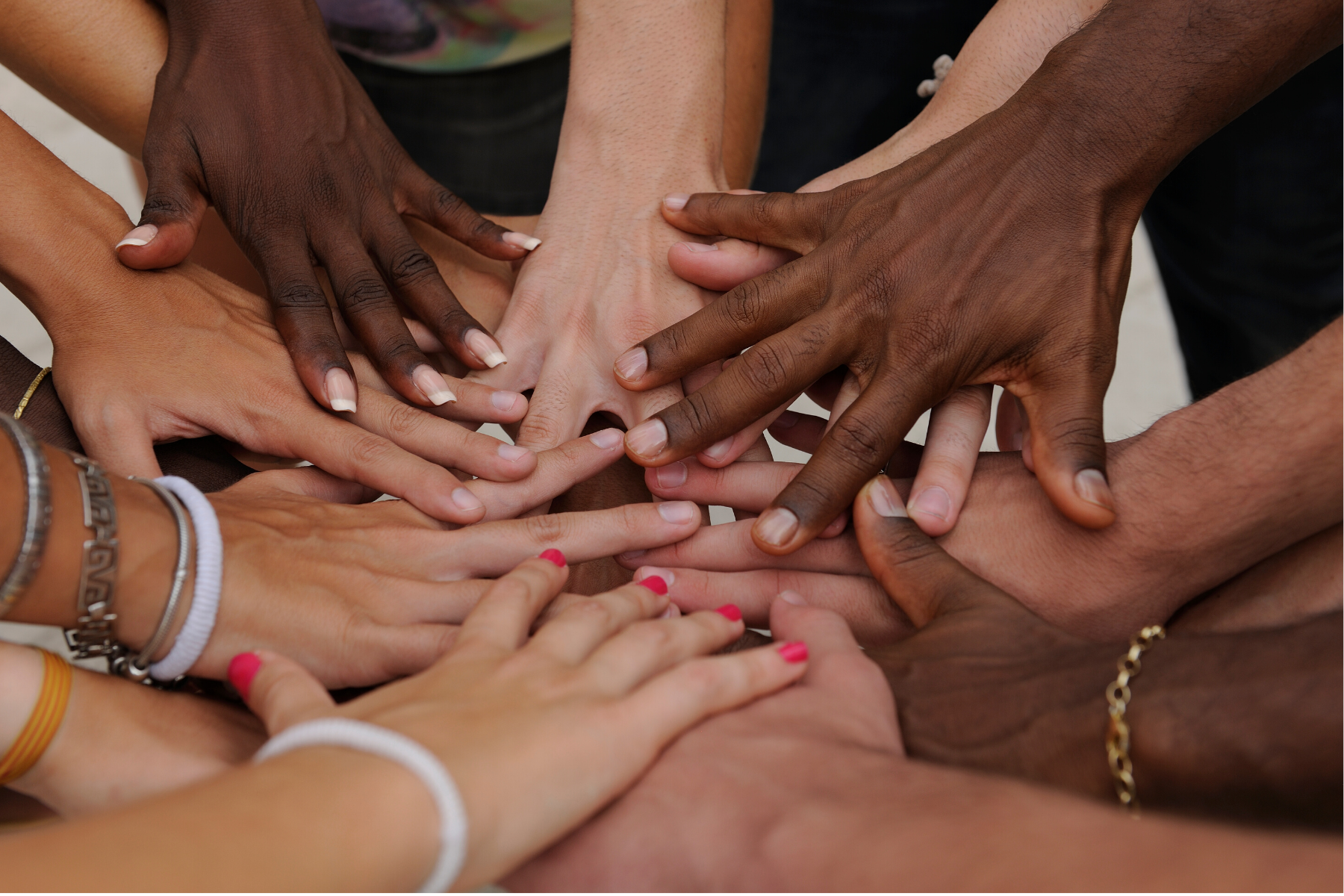 focus on our humanity, multiracial hands together