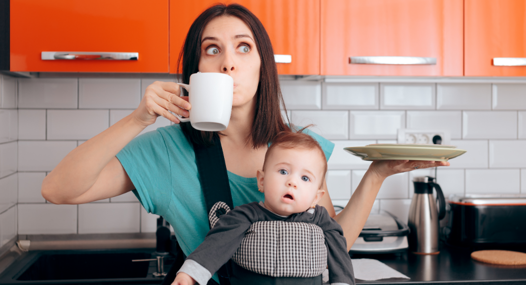 stop multitasking; mom drinking coffee with baby