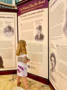young girl learning about women's history in the WI state capital