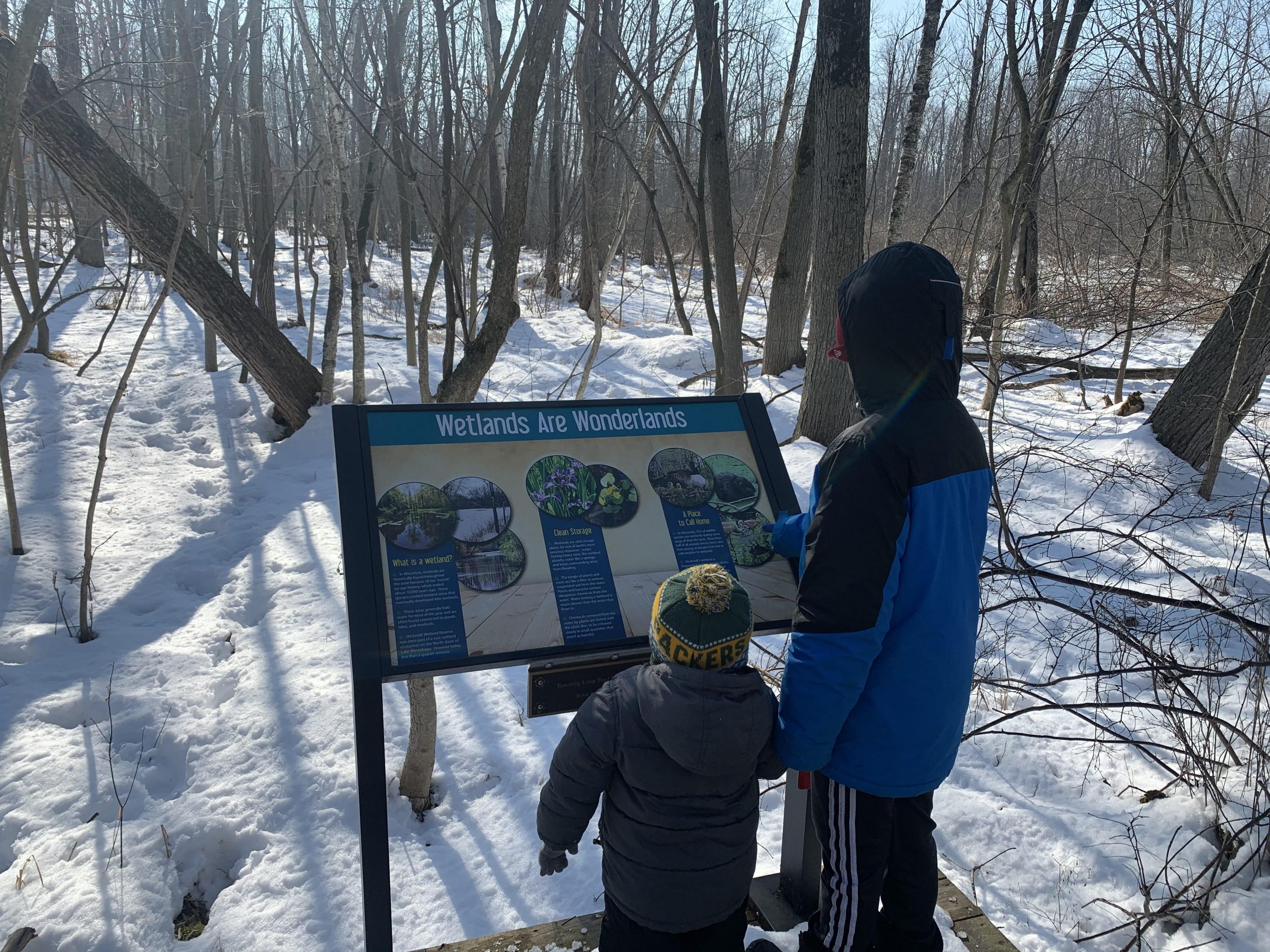 2 children looking at trail sign at Heckrodt Wetland Reserve