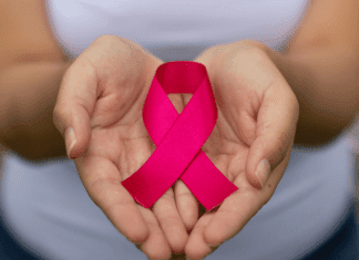 you have breast cancer; hands holding pink ribbon