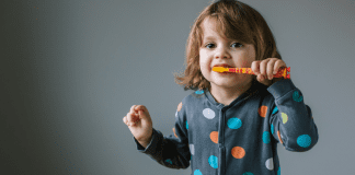 OHP Nonprofit Spotlight; young girl brushing teeth